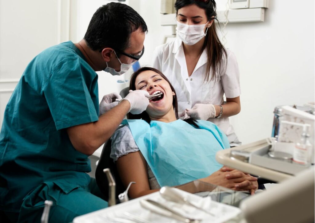 Patient receiving restorative dental treatment to fix grinded teeth and restore a healthy, natural-looking smile.