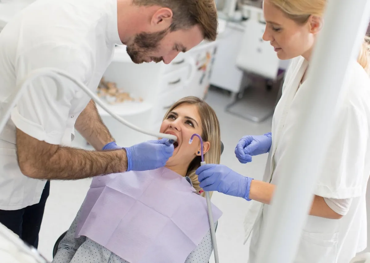 Dentist examining a patient’s teeth for signs of cavities during a dental checkup.